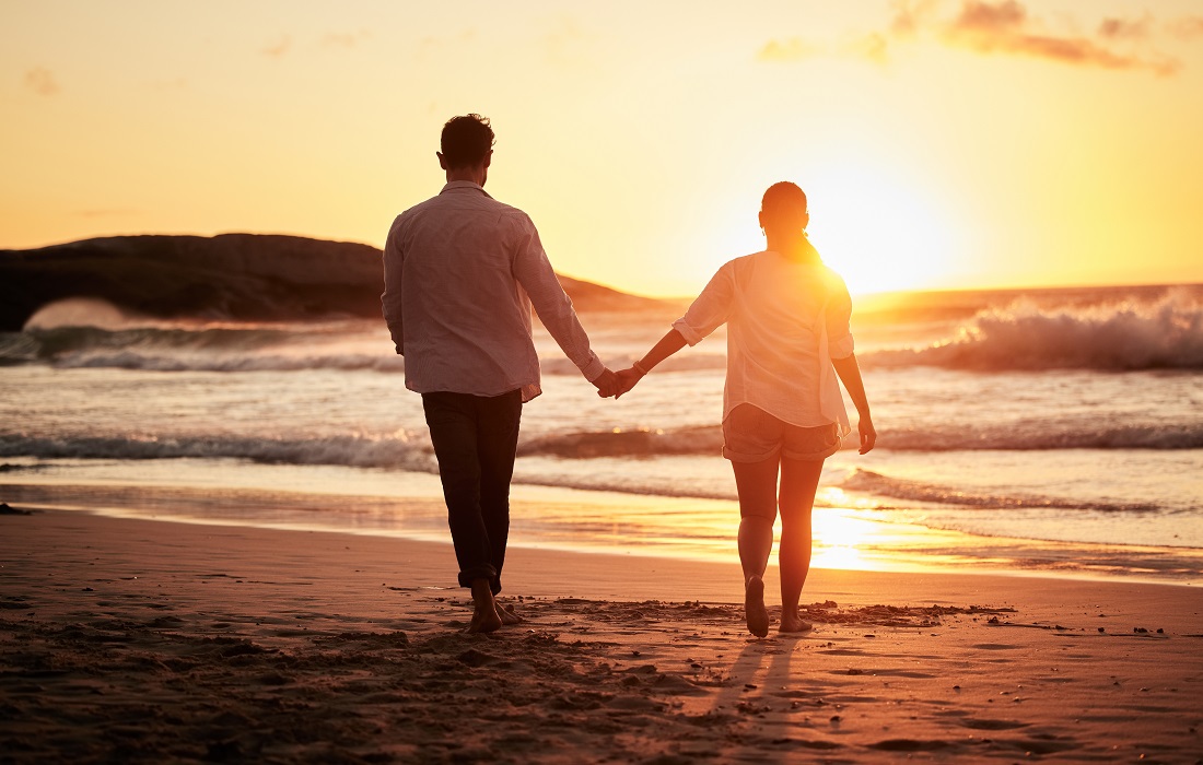 Sunset, Couple Holding Hands And Walking on beach