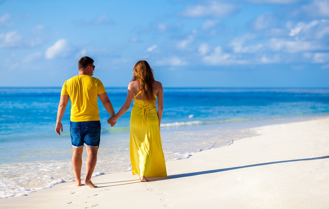 Maldives, a couple walking along the beach