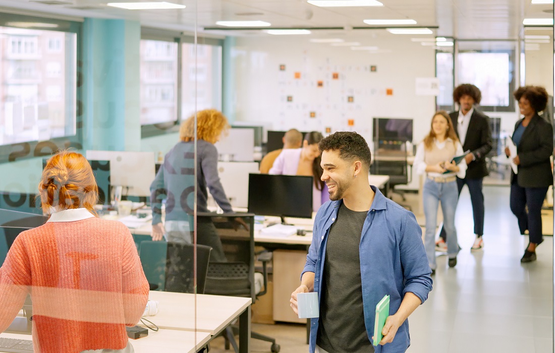 coworkers-arriving-at-the-office-and-sitting-on-desk